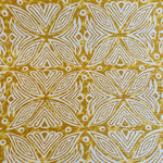 Detail of fabric in a botanical geometric print in shades of brown, yellow and white.