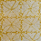 Detail of fabric in a botanical geometric print in shades of brown, yellow and white.