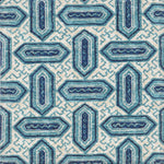 Detail of fabric in a dense geometric print in shades of blue and navy on a cream field.