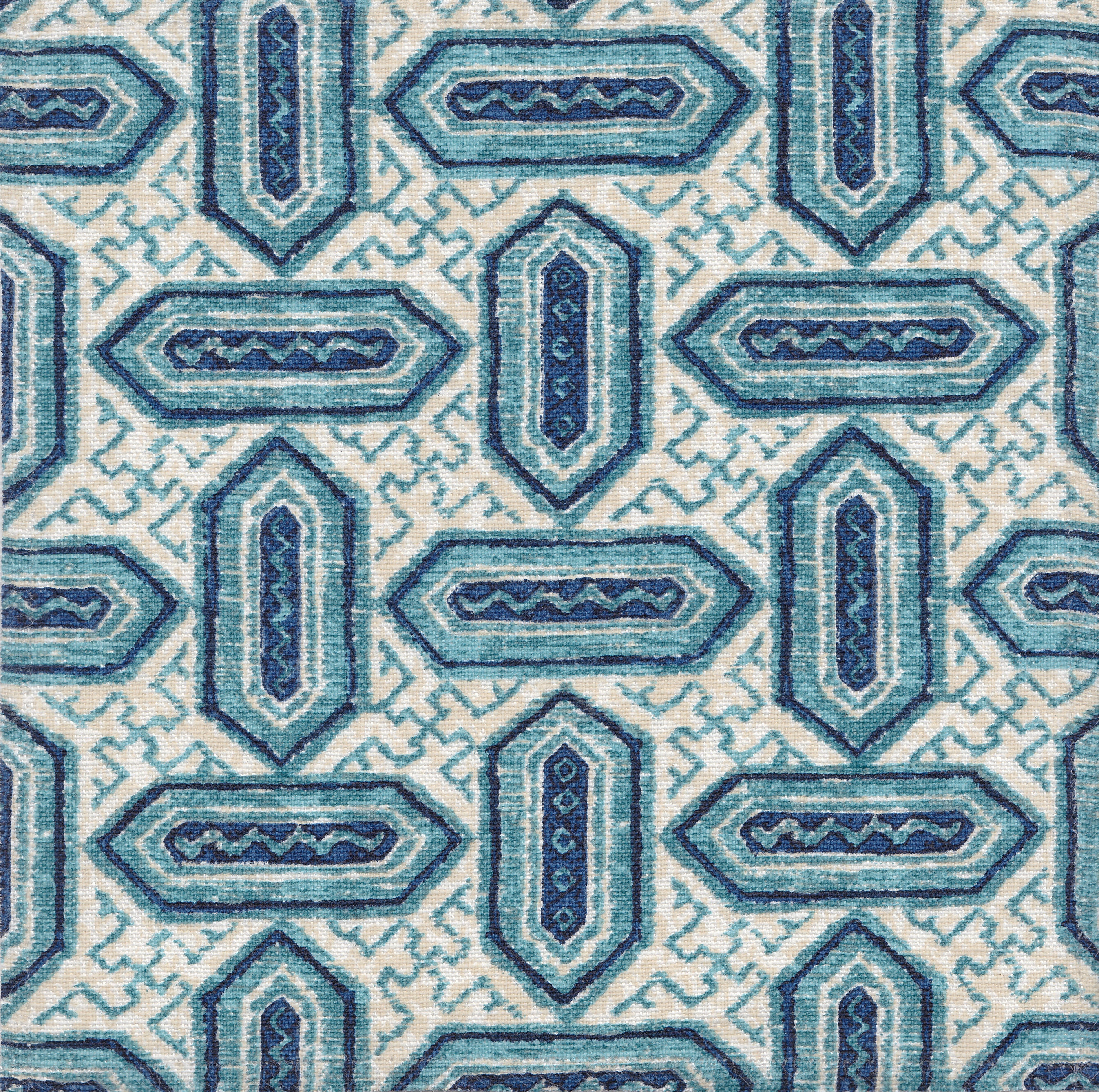 Detail of fabric in a dense geometric print in shades of blue and navy on a cream field.