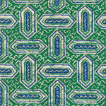 Detail of fabric in a dense geometric print in shades of blue and green on a cream field.