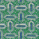 Detail of fabric in a dense geometric print in shades of blue and green on a cream field.