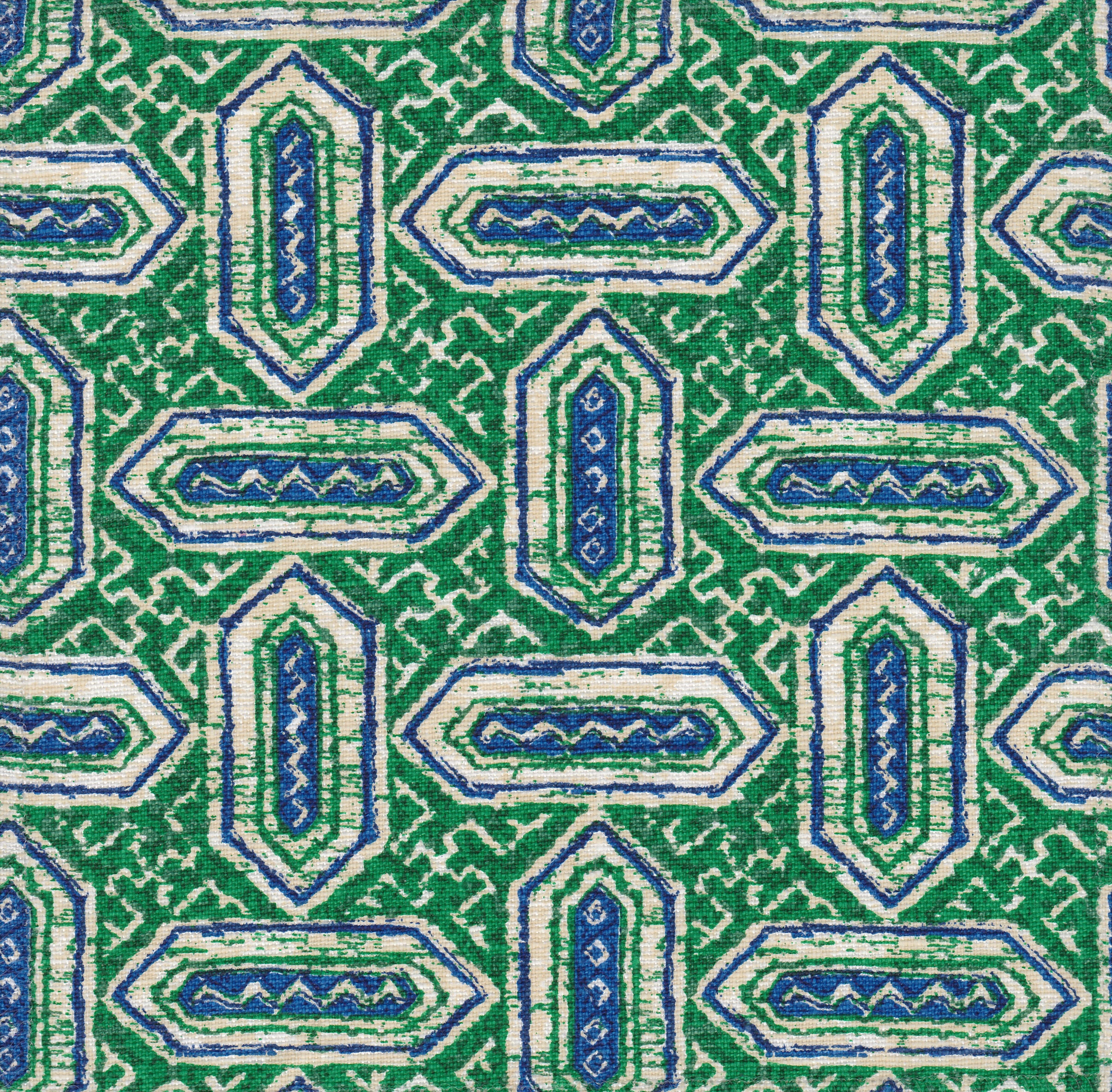 Detail of fabric in a dense geometric print in shades of blue and green on a cream field.