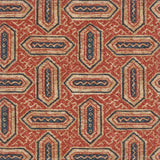 Detail of fabric in a dense geometric print in shades of navy and rust on a tan field.