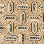 Detail of fabric in a dense geometric print in shades of navy and tan on a cream field.