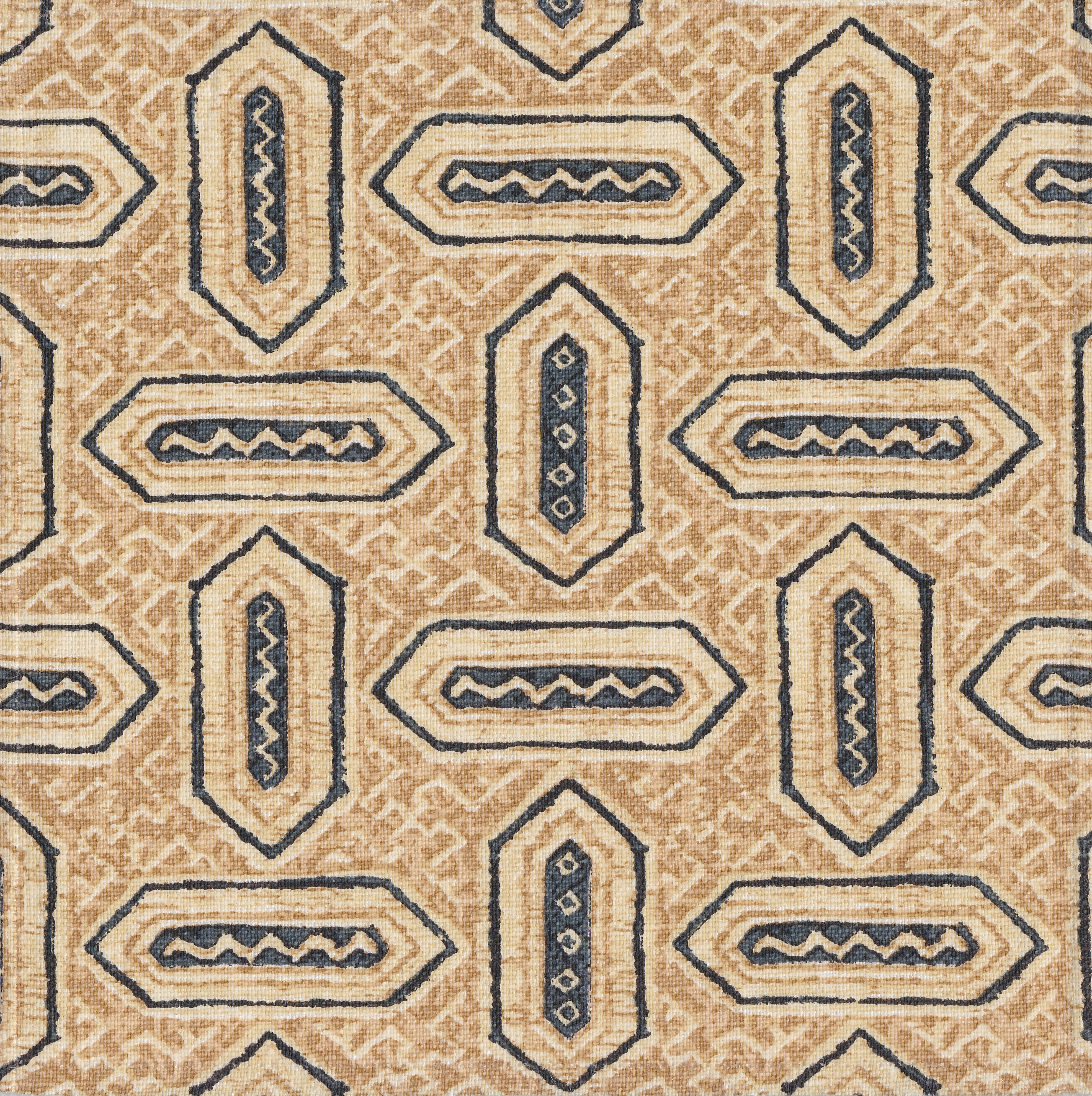 Detail of fabric in a dense geometric print in shades of navy and tan on a cream field.