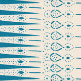 Detail of fabric in a bordered teardrop print in turquoise on a cream field.