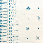 Detail of fabric in a bordered teardrop print in blue on a cream field.