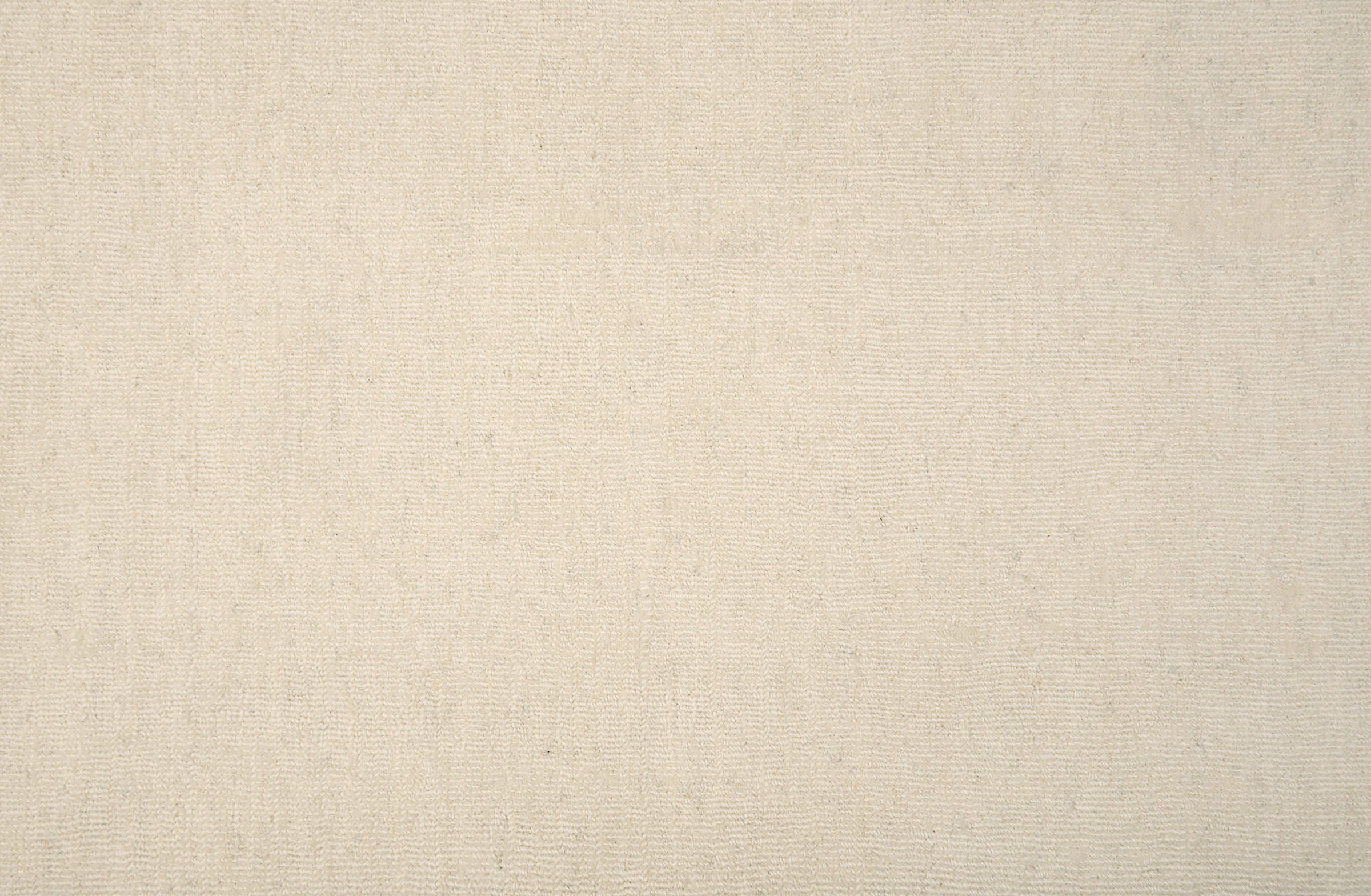 Solid broadloom carpet in cream. 