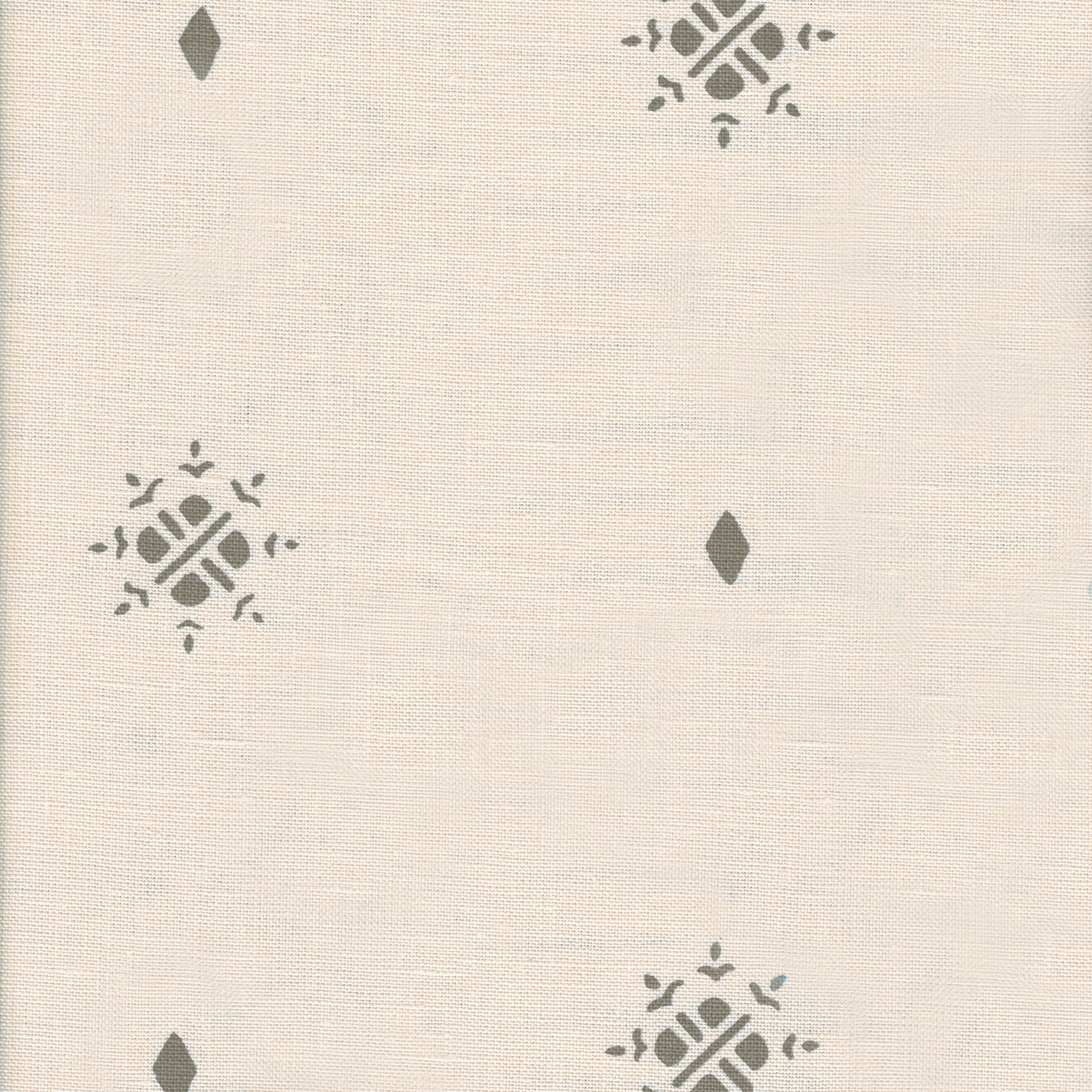 Detail of fabric in a repeating geometric starburst print in gray on a cream field.