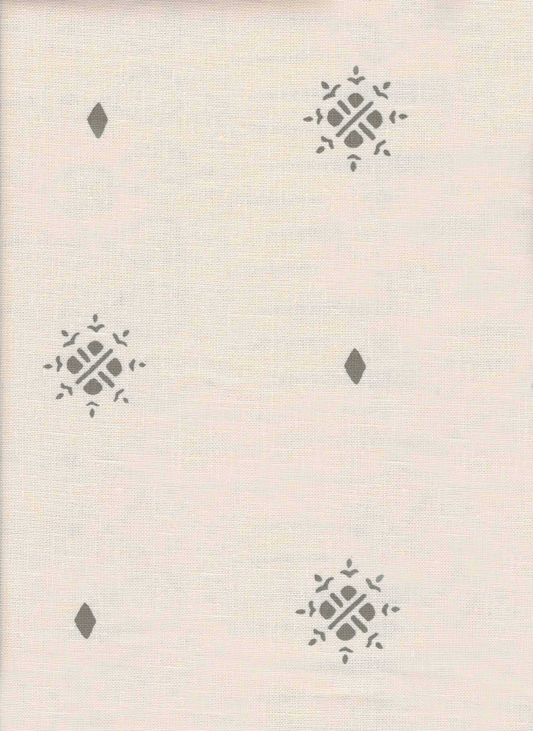 Detail of fabric in a repeating geometric starburst print in gray on a cream field.