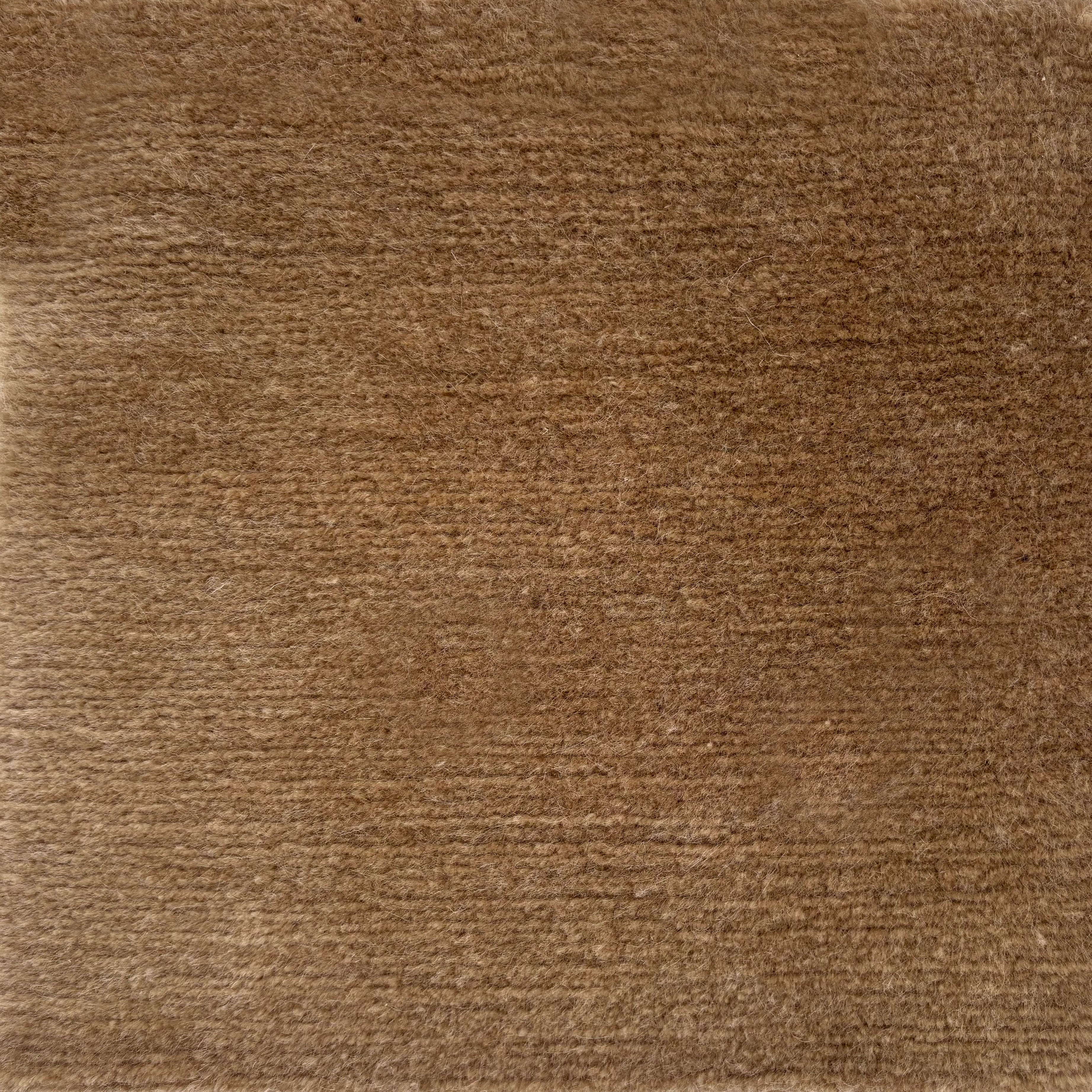 Handknotted cut pile rug in warm taupe.