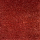 Handknotted cut pile rug in rust red.