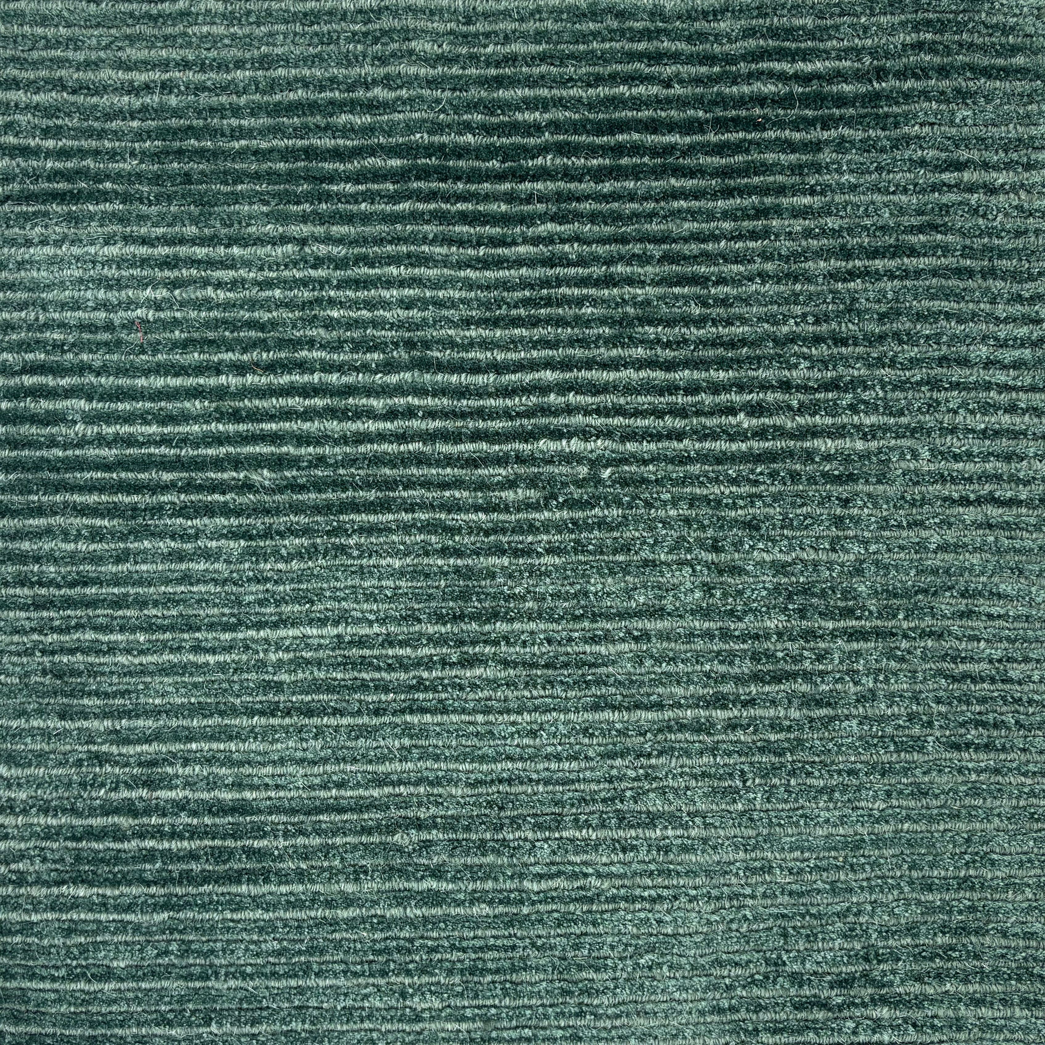 Handknotted cut pile & ribbed rug in teal. 