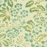 Detail of fabric in a floral print in mottled turquoise and green on a cream field.