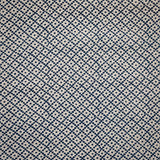 Detail of fabric in a diamond lattice print in navy on a cream field.