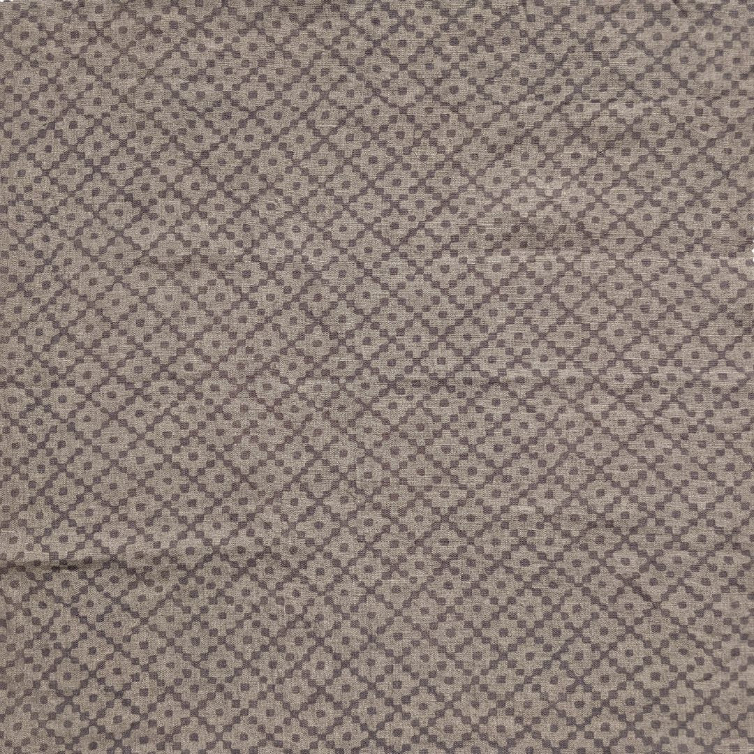 Detail of fabric in a diamond lattice print in gray on a greige field.