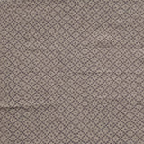 Detail of fabric in a diamond lattice print in gray on a greige field.