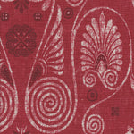 Detail of fabric in a damask print in shades of white and purple on a red field.