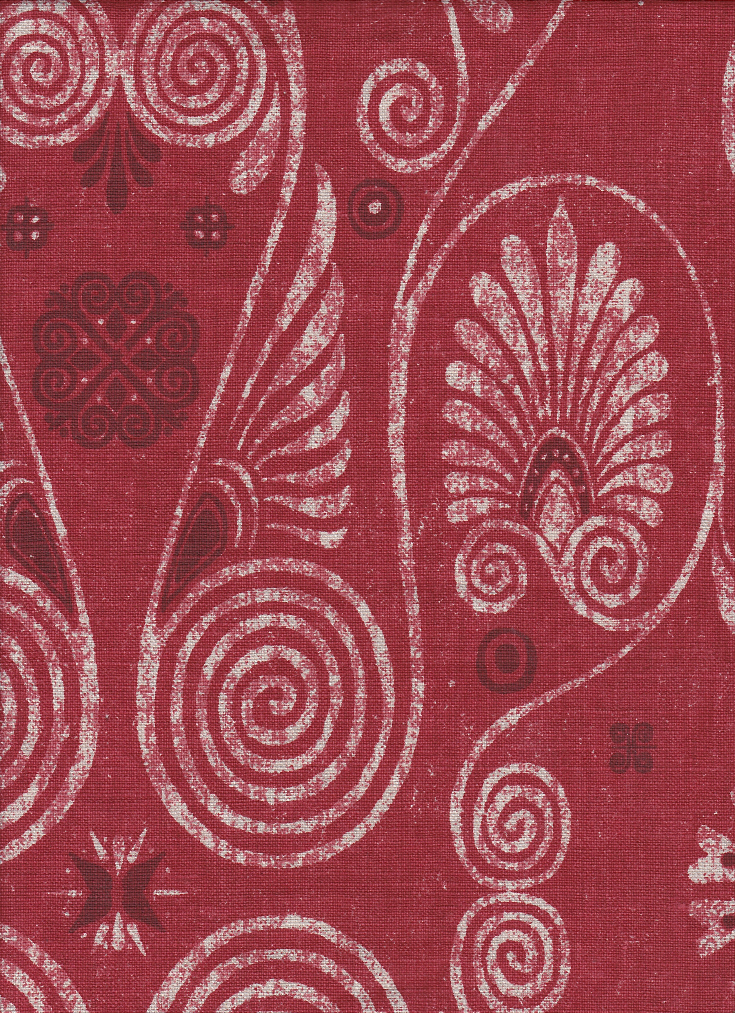 Detail of fabric in a damask print in shades of white and purple on a red field.