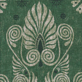 Detail of fabric in a damask print in shades of dark green and cream on a green field.