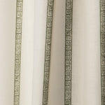 Draped printed fabric in a minimal geometric linear pattern in sage on a cream field.