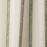 Draped printed fabric in a minimal geometric linear pattern in sage on a cream field.