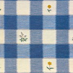 Checkered fabric with yellow flowers on a blue and white checkered background