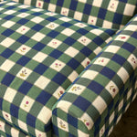 Green and blue checkered sofa with floral patterns