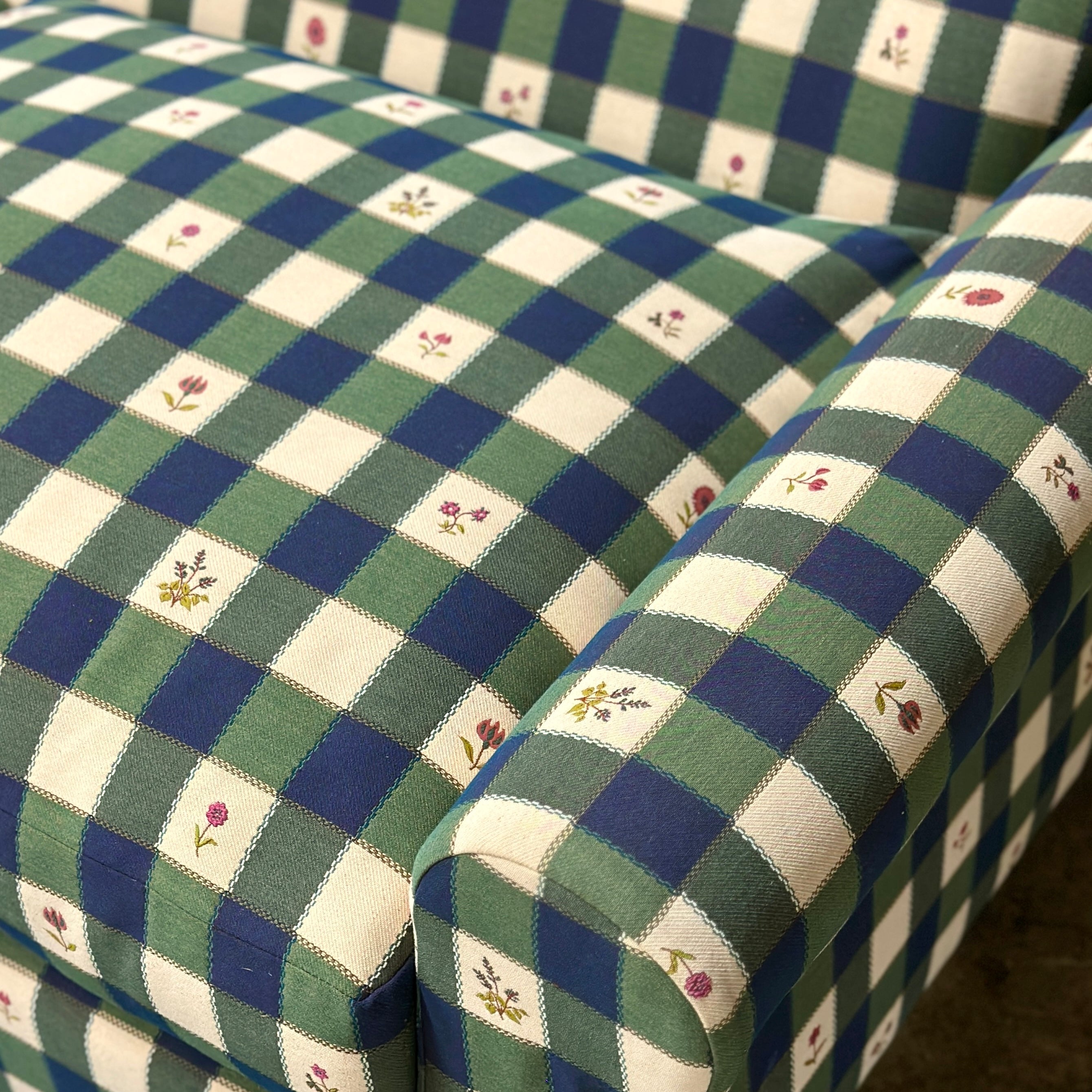 Green and blue checkered sofa with floral patterns