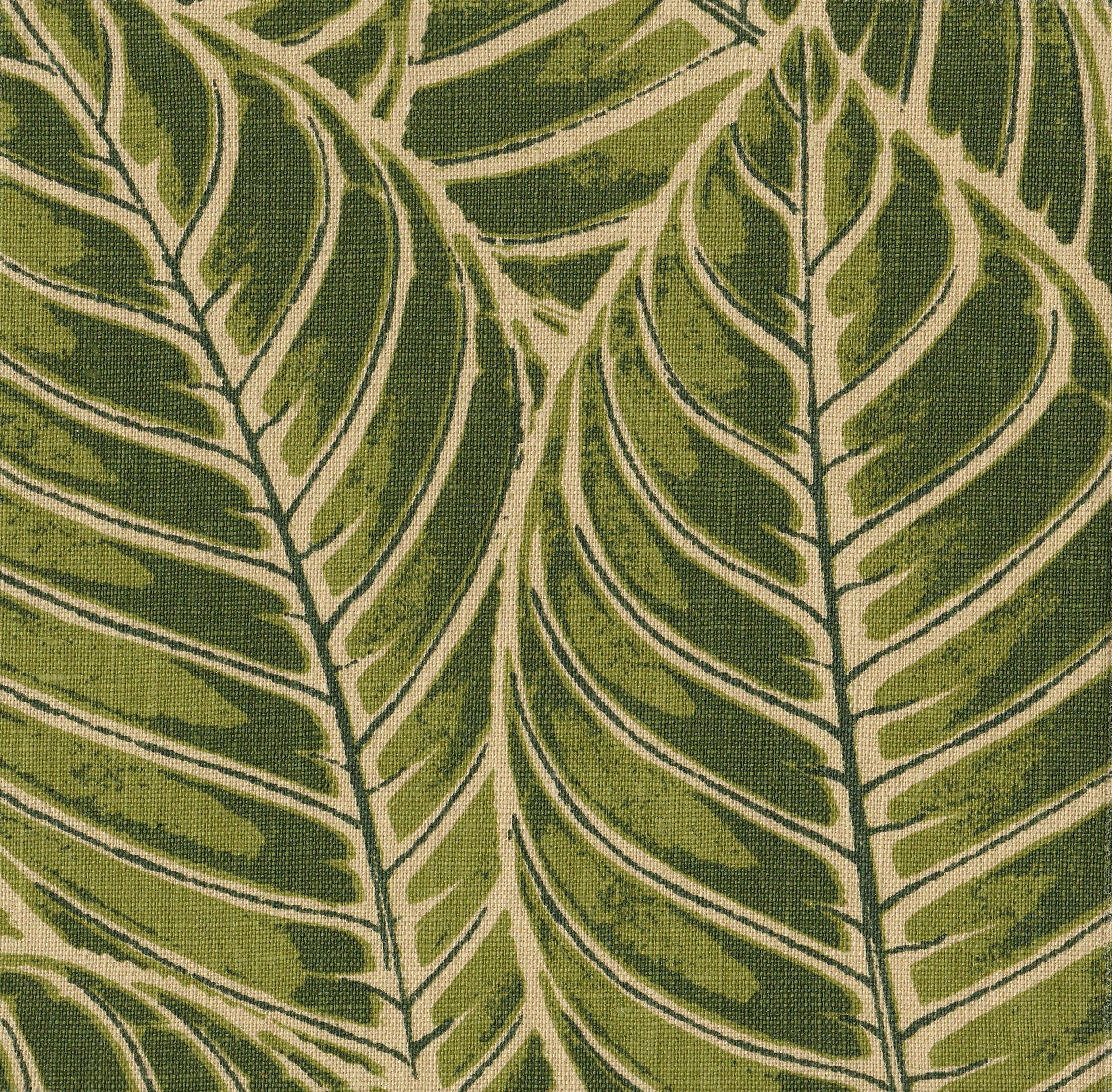 Detail of fabric in a large-scale leaf print in shades of green on a tan field.