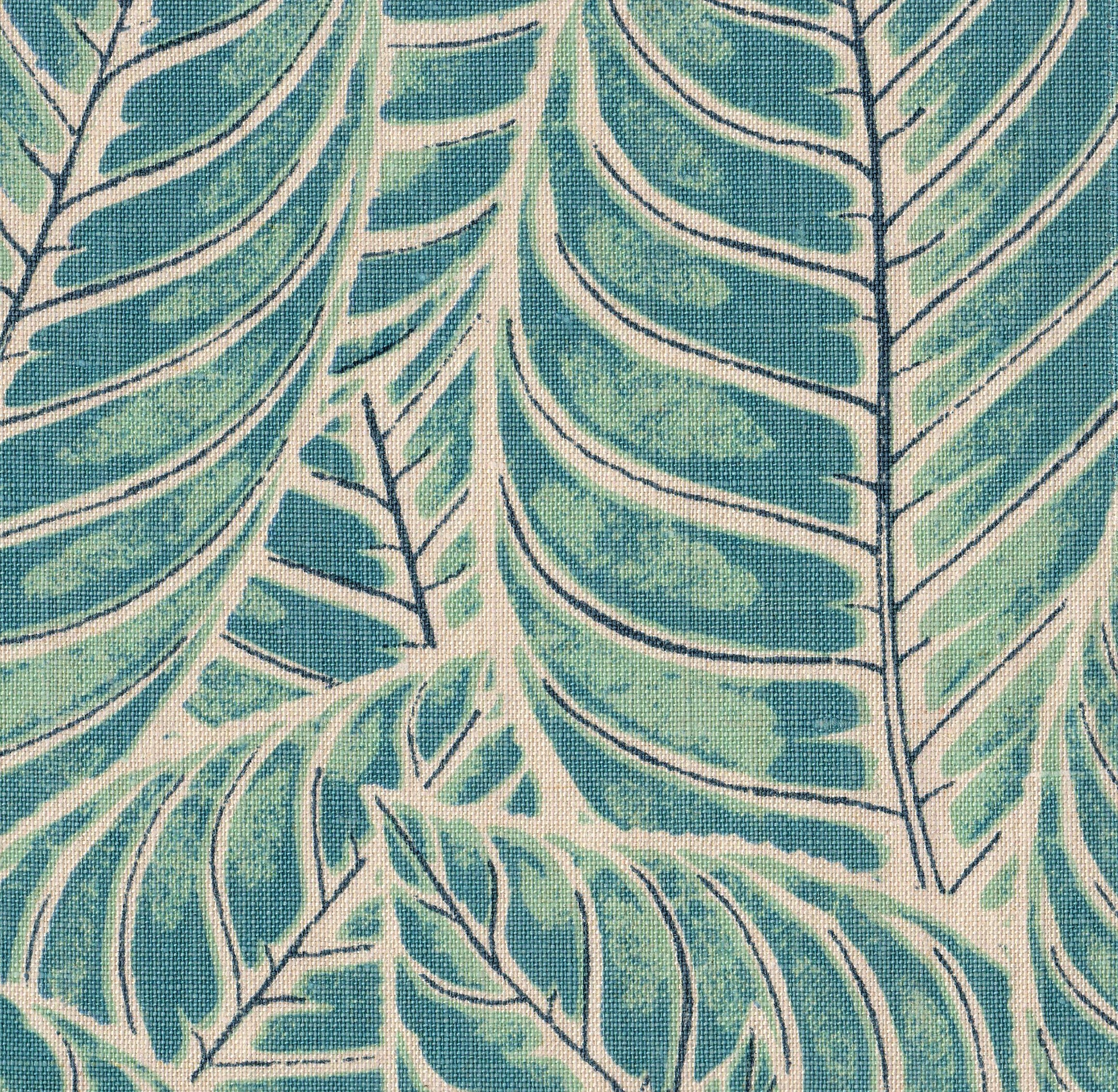 Detail of fabric in a large-scale leaf print in shades of blue and turquoise on a tan field.