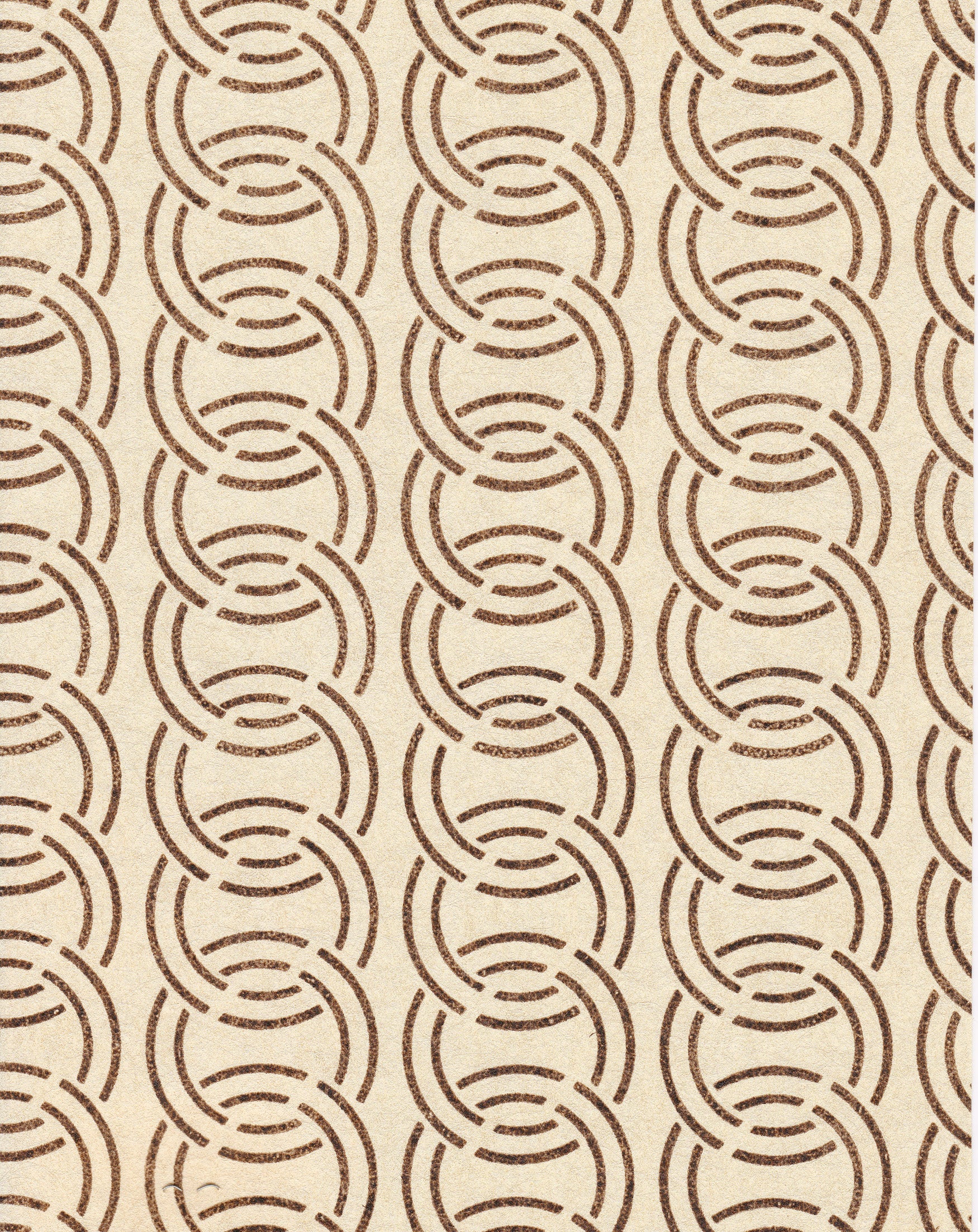 Detail of wallpaper in an interlocking circular pattern in mottled brown on a cream field.