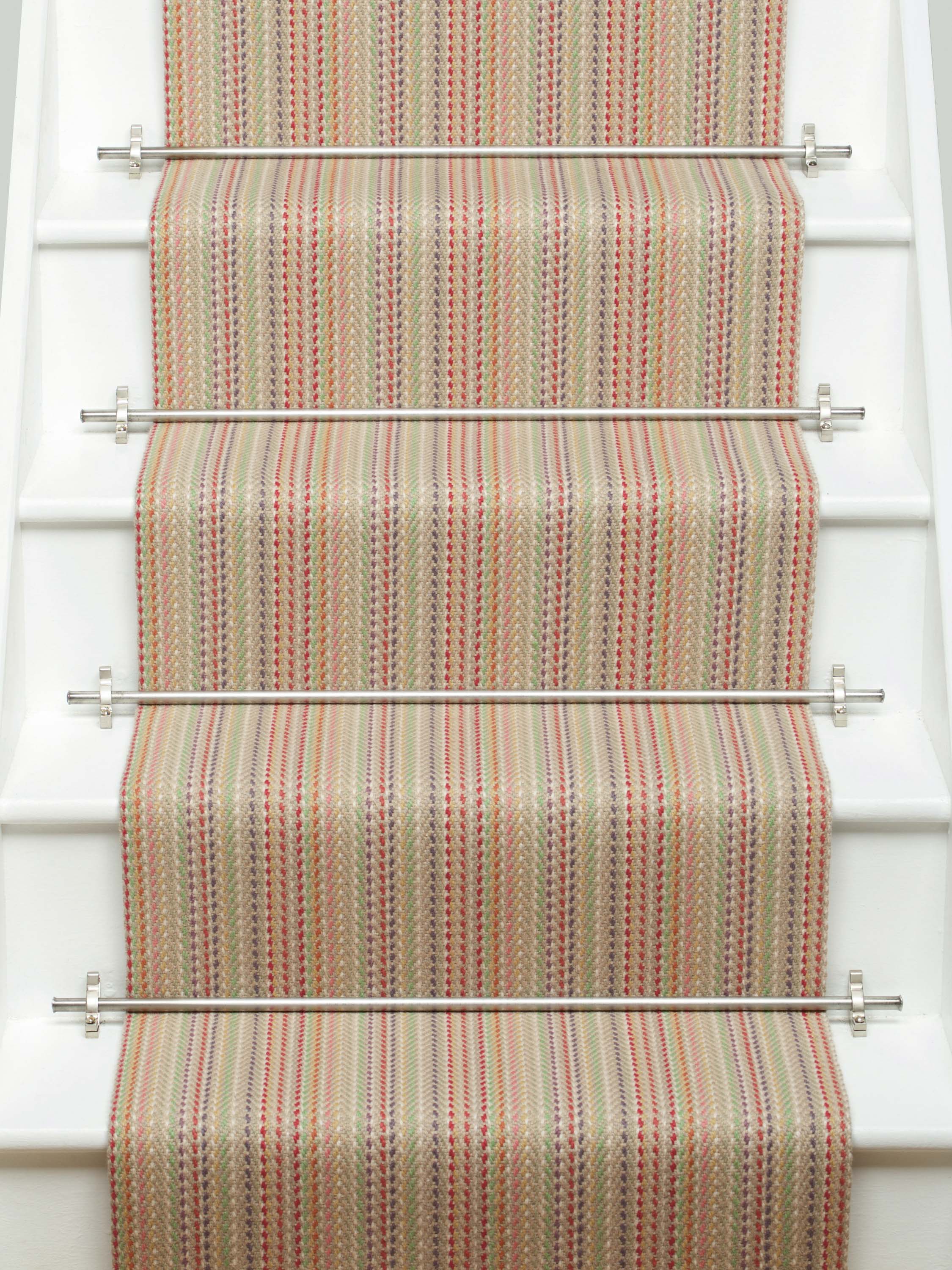 Striped flatweave runner in red green blue orange on white staircase