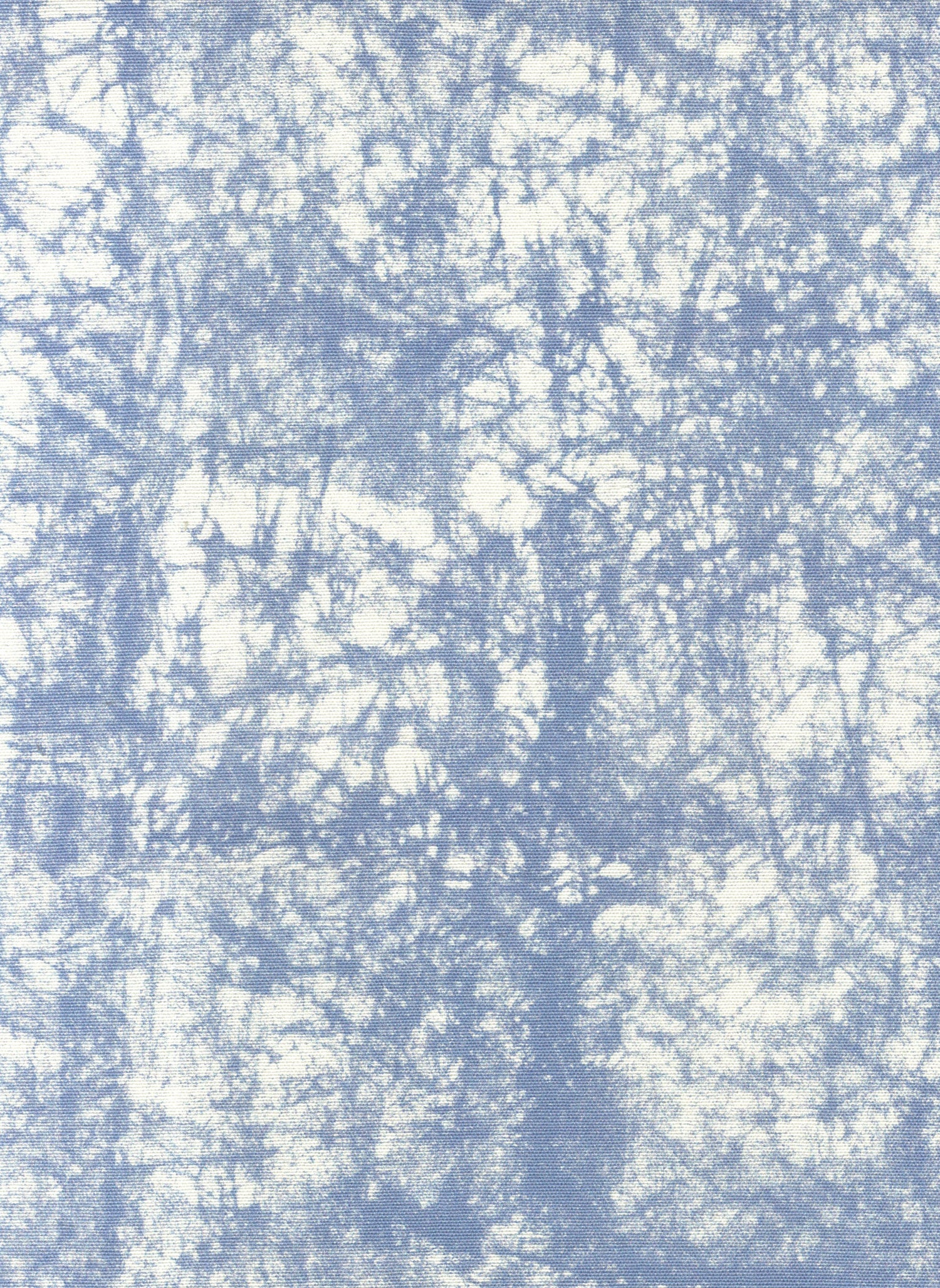 Detail of fabric in a textural splatter print in blue on a cream field.