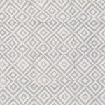 Detail of fabric in a geometric diamond print in gray on a cream field.