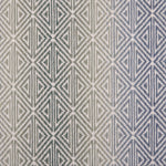 Broadloom carpet with triangle pattern with an ombré background in blue and green. 