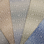 Collection of broadloom carpet swatches with geometric patterns in various colors.
