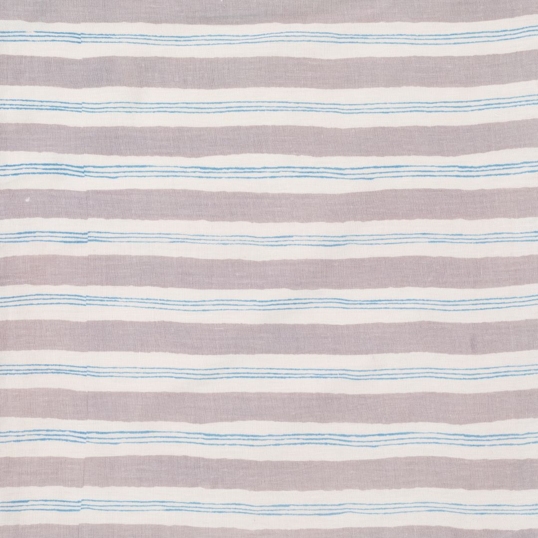 Detail of fabric in a painterly striped pattern in light gray and blue on a cream field.