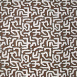 Fabric in an abstract meandering shape print in white and gray on a brown field.