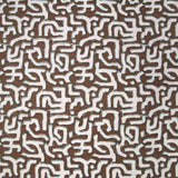 Fabric in an abstract meandering shape print in white and gray on a brown field.