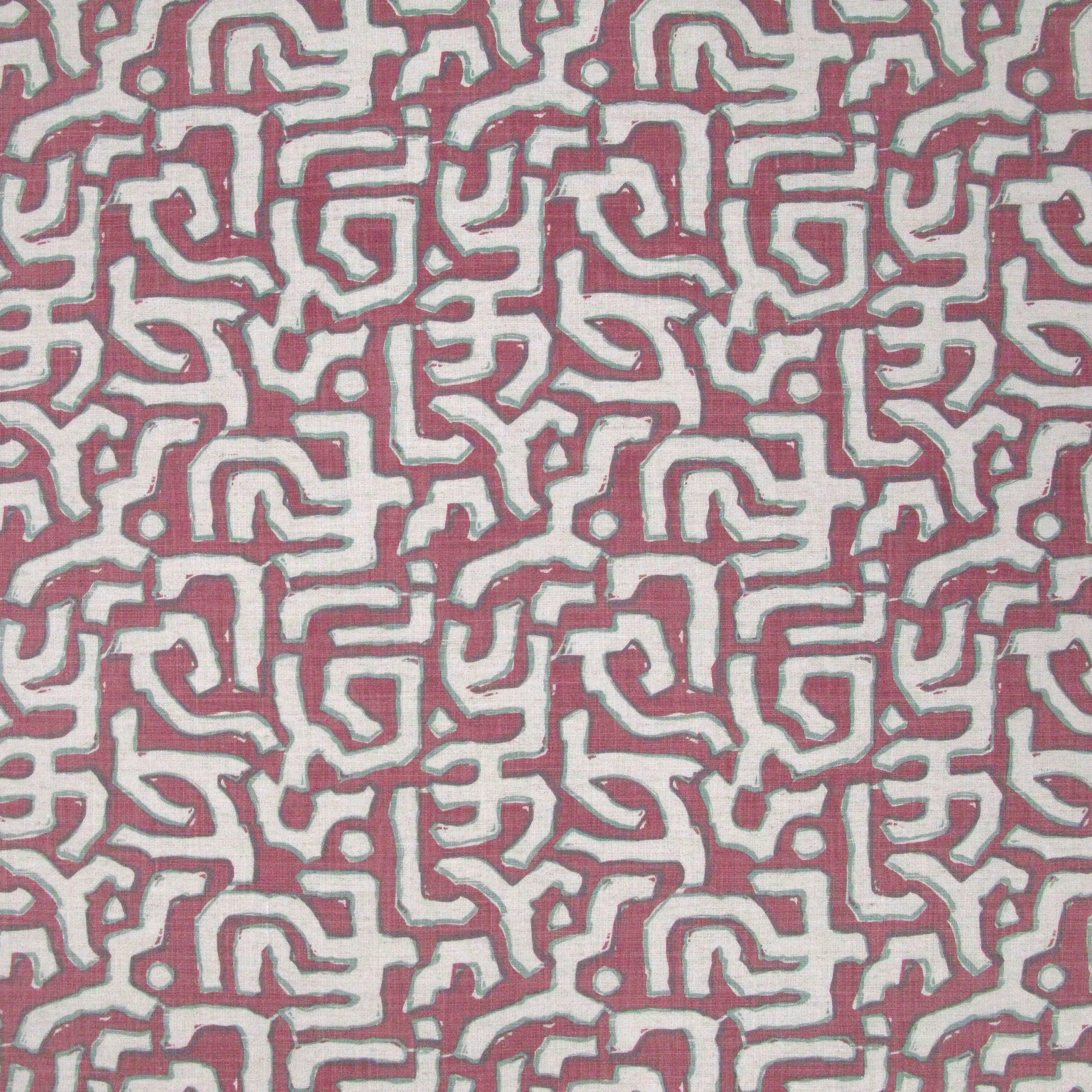 Fabric in an abstract meandering shape print in white and sage on a pink field.