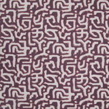 Fabric in an abstract meandering shape print in white and pink on a maroon field.