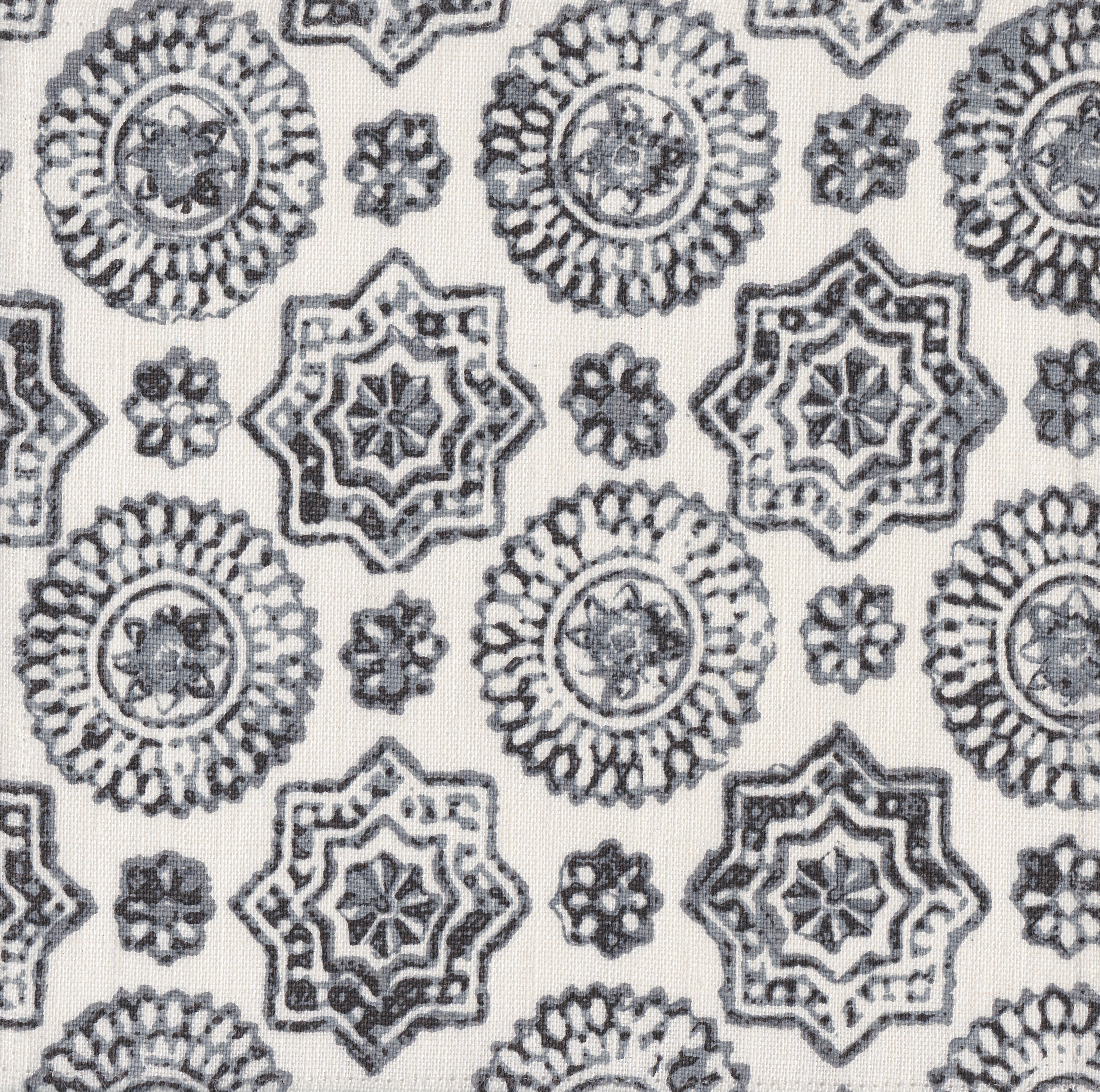 Detail of fabric in a geometric damask print in shades of gray on a cream field.