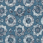 Detail of fabric in a geometric damask print in shades of navy and white on a blue field.