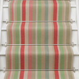 Striped flatweave runner in green pink blue red yellow on white staircase