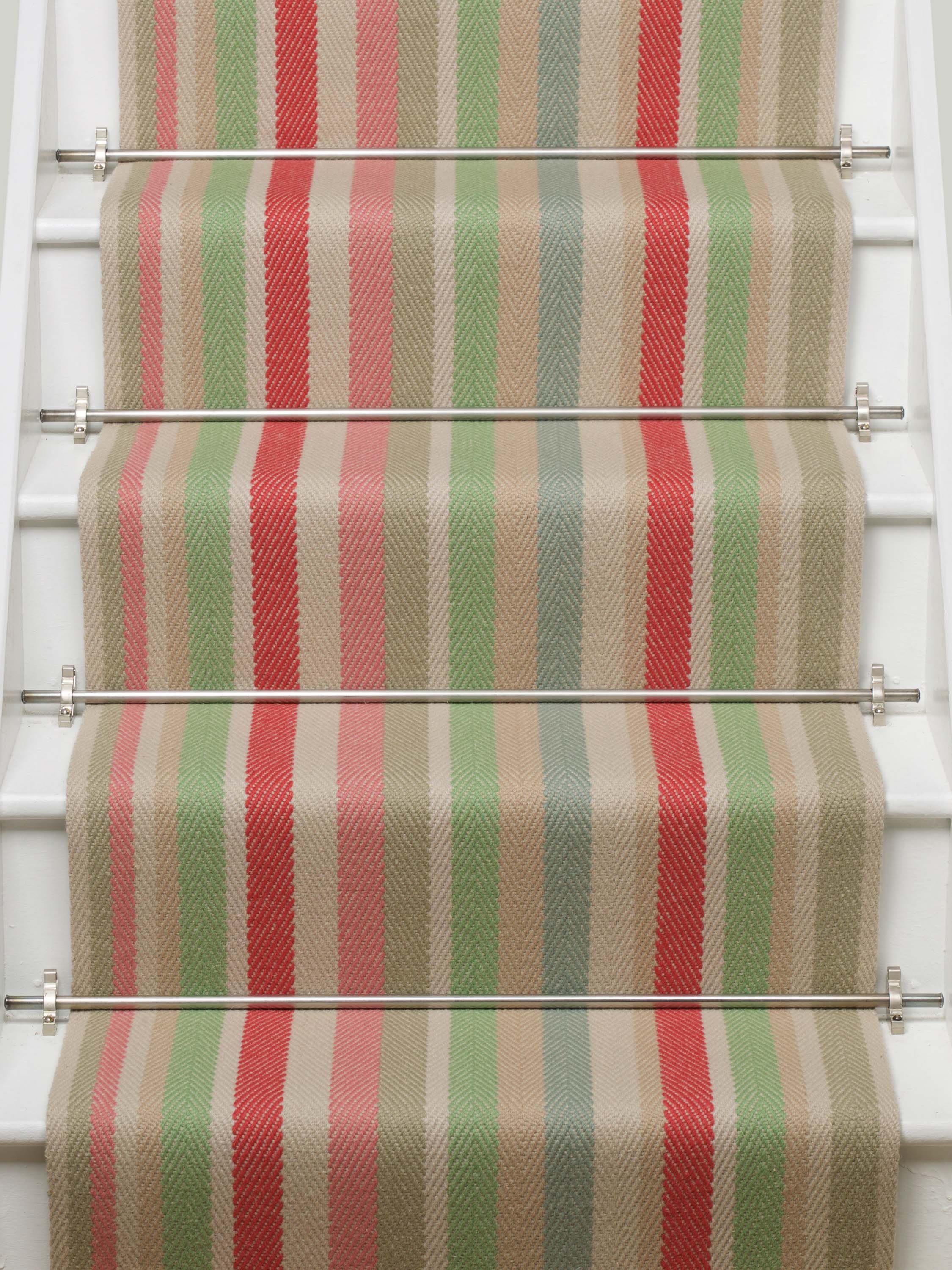 Striped flatweave runner in green pink blue red yellow on white staircase