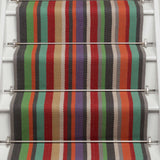 Striped flatweave runner in green blue purple orange red on white staircase