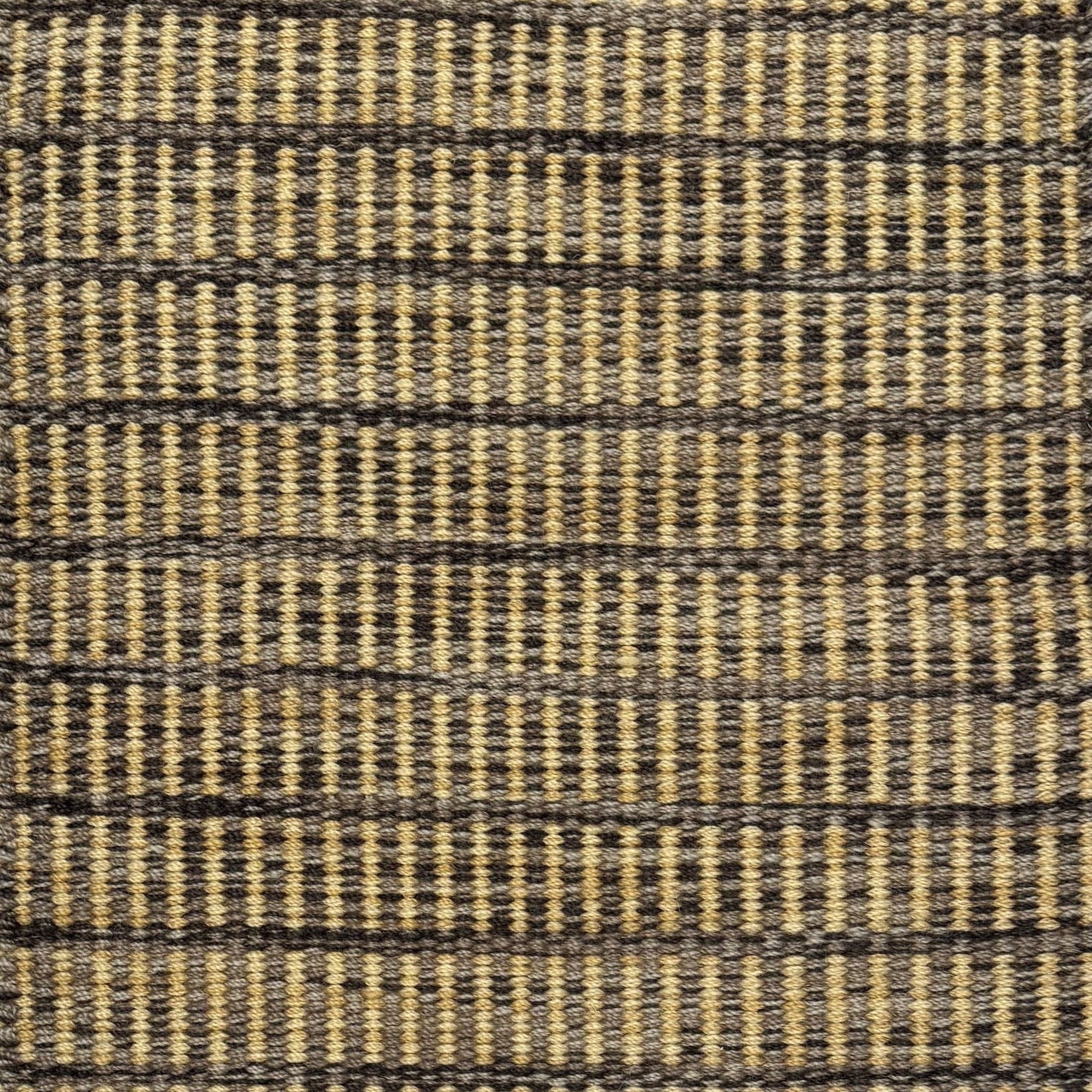 Textured rug with a taupe, brown and tan checker pattern