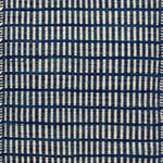 Textured rug with a blue and ivory checker pattern